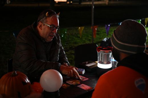 A tarot reading underway at night